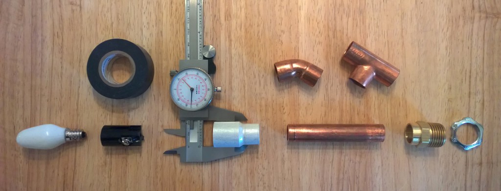 Left to right, candelabra (E12) 7W night light bulb, candelabra (E12) socket, electrical tape, 3/4" to 1/2" copper coupling, 1/2" copper pipe and fittings, 1/2" to 3/4" threaded brass adapter, 1/2" electrical bushing nut